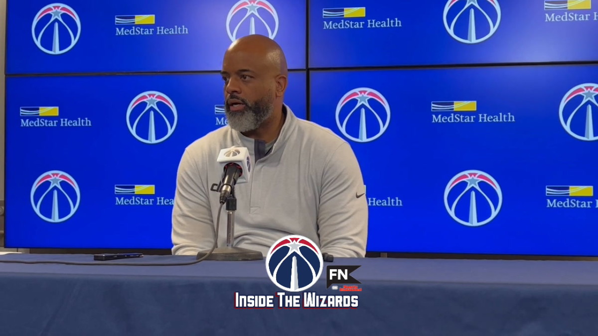 Coach Wes Unseld talking strategy to the media 